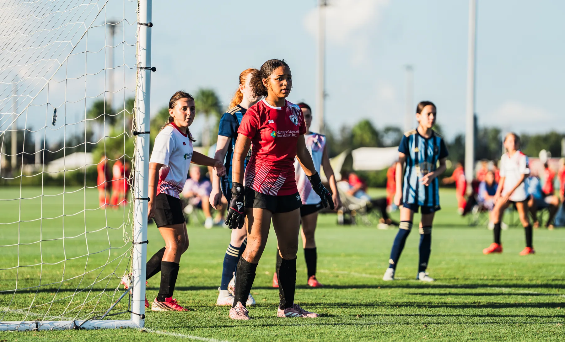 Girls team and goalkeeper during a Florida Easter Cup match